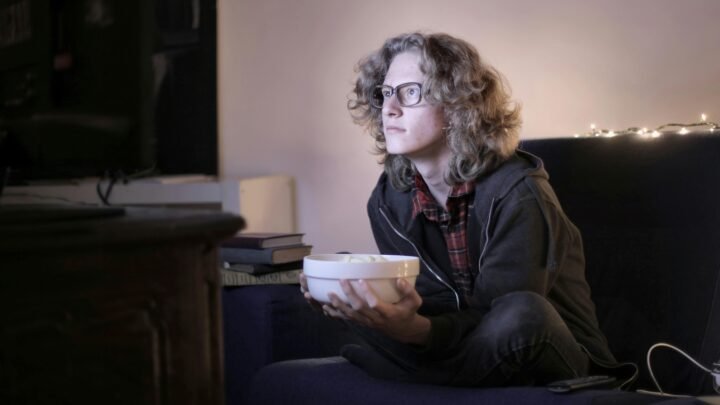 Person relaxing at home while watching entertainment content